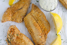 Load image into Gallery viewer, air fried fish on parchment paper with lemon slices
